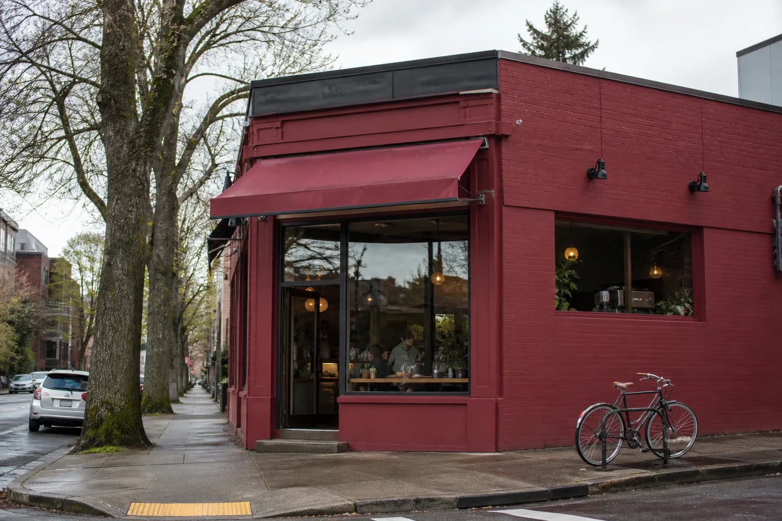 The deep-red corner storefront of a Stumptown Coffee Roasters cafe in Portland
