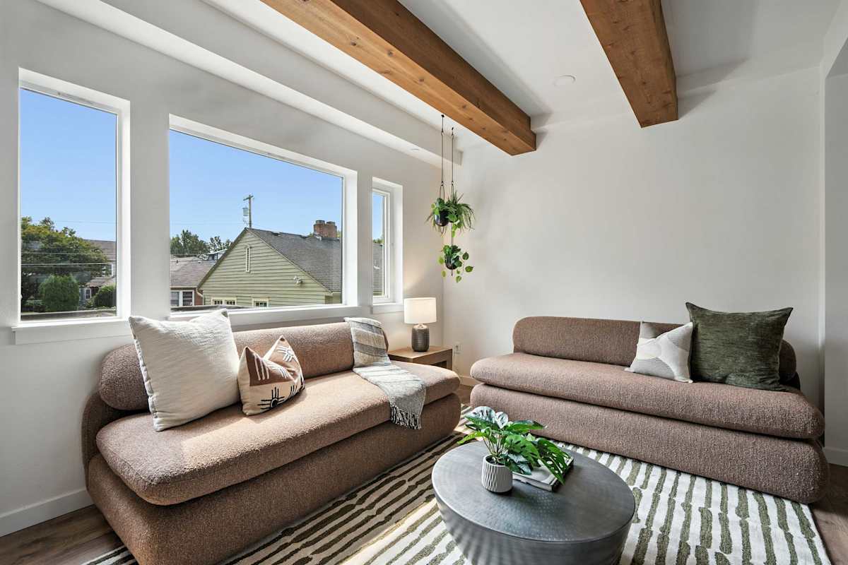 Living room with sofa and bright windows.