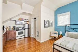 Vaulted-Ceiling Studio · Full Kitchen + Laundry