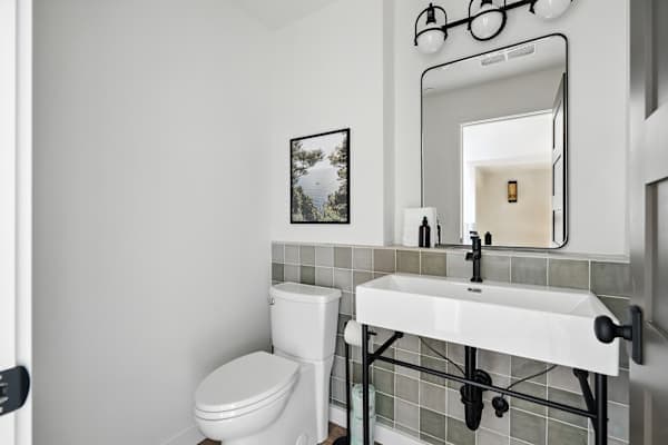 Half bathroom with vanity and toilet.
