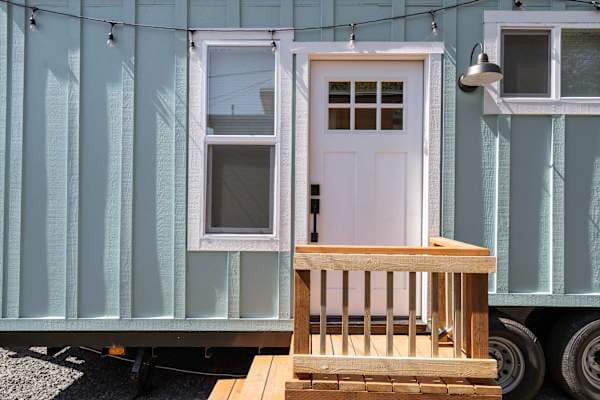 Exterior entry to the blue tiny home.