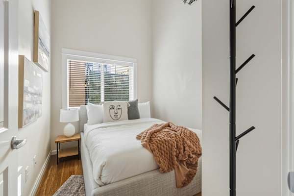Bedroom 1 with queen bed and window.