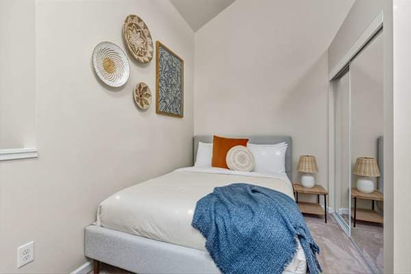 Bedroom 2 with queen bed and wall art.