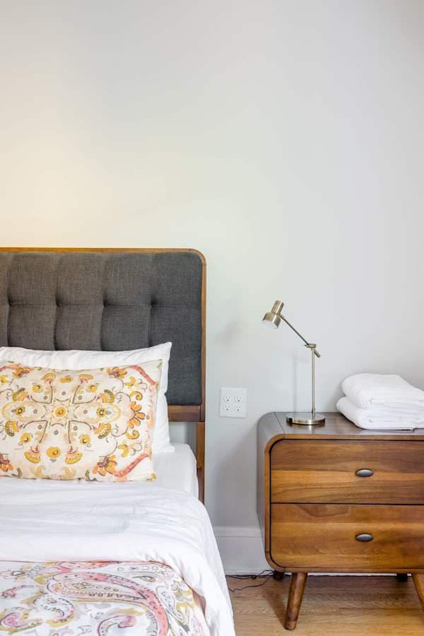 Bedroom 1 with queen bed and gray headboard.